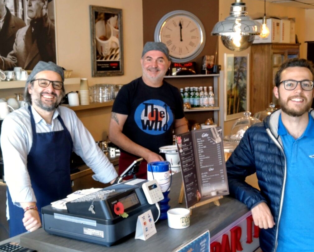 Leonardo and Daniele smiling behind the counter at Bar Italiano